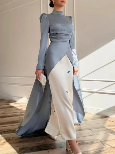 Modest black dress side view showing relaxed silhouette and woven texture